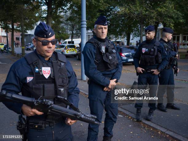 French police stand at the entrance of the Gambetta-Carnot public school where Dominique Bernard, a teacher, was fatally stabbed yesterday, on...