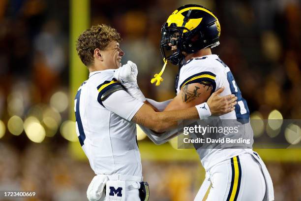 McCarthy and AJ Barner of the Michigan Wolverines celebrate a touchdown against the Minnesota Golden Gophers in the second half at Huntington Bank...