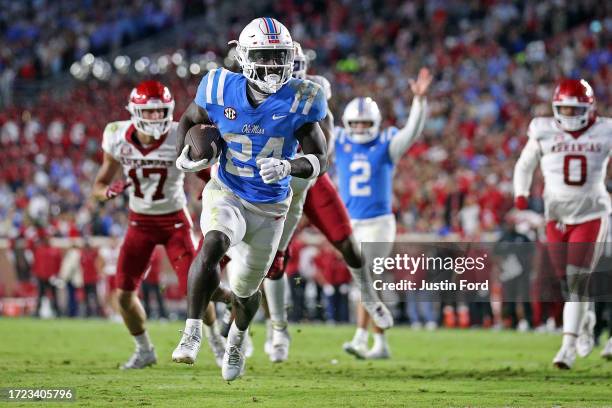 Ulysses Bentley IV of the Mississippi Rebels scores a touchdown against the Arkansas Razorbacks during the second half at Vaught-Hemingway Stadium on...