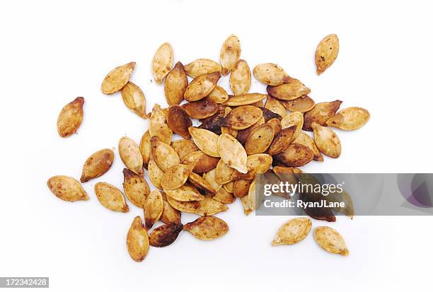 fresh roasted pumpkin seeds isolated on white - roasted stock pictures, royalty-free photos & images
