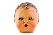 A creepy female doll head with yellow eyes
