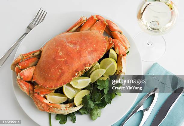 dungeness crab seafood dinner, cooked, prepared, and served with wine - crab stock pictures, royalty-free photos & images