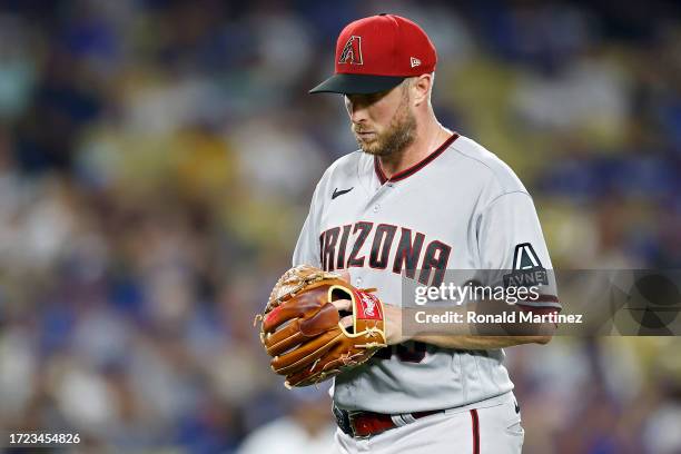 Merrill Kelly of the Arizona Diamondbacks walks off the field after being relieved in the seventh inning against the Los Angeles Dodgers during Game...