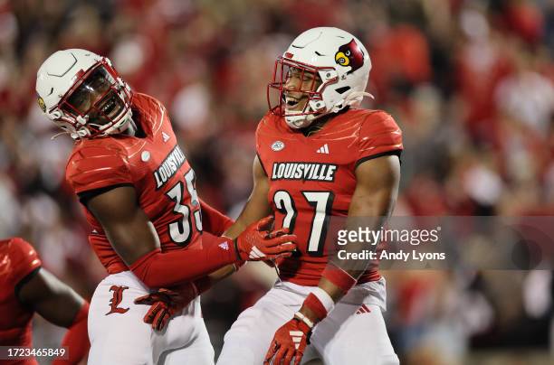Antonio Watts and Devin Neal of the Louisville Cardinals celebrate during the 33-20 win over the Notre Dame Fighting Irish at L&N Stadium on October...