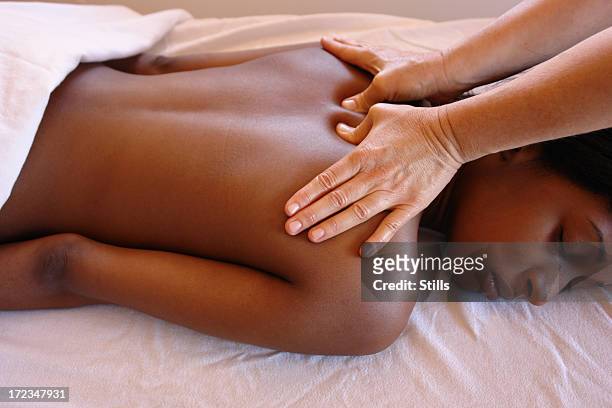 young woman getting a deep tissue massage - shiatsu stock pictures, royalty-free photos & images