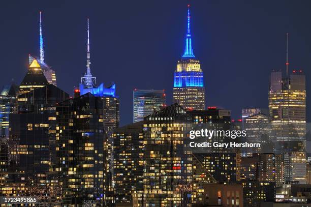 The Empire State Building illuminates in the colors of the flag of Israel in New York City on October 7 as seen from North Bergen, New Jersey.