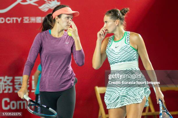 Anna Danilina of Kazakhstan and Alexandra Panova talk during the women's doubles semi-final match against Oksana Kalashnikova of Georgia and...