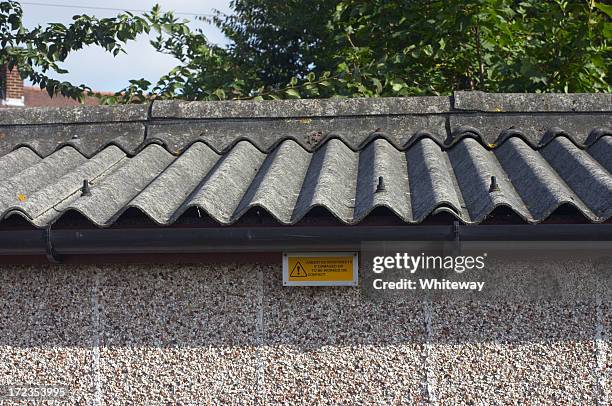 asbestos roof and warning sign - asbestos stock pictures, royalty-free photos & images