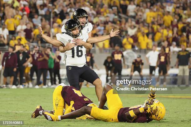 Place kicker Alejandro Mata of the Colorado Buffaloes celebrates with holder Mark Vassett after making a 43-yard field goal against the Arizona State...