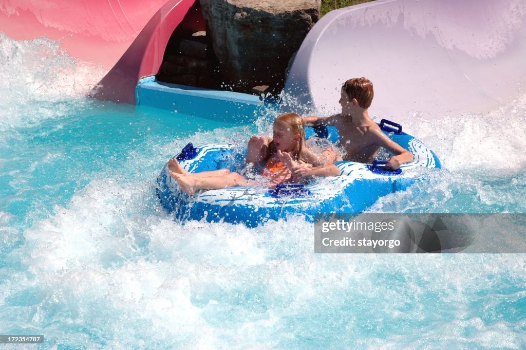 Two children going down a water slide