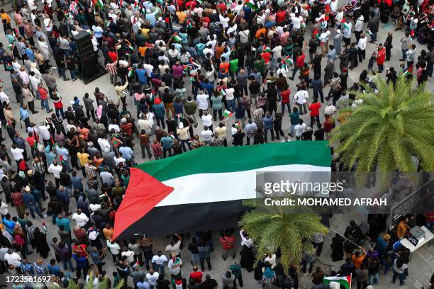 Demonstrators gather to show solidarity with Palestinians during a rally held in the artificial beach region in the capital city of Male on October...