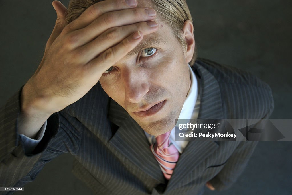 Nervous Businessman Wiping Sweat from his Brow