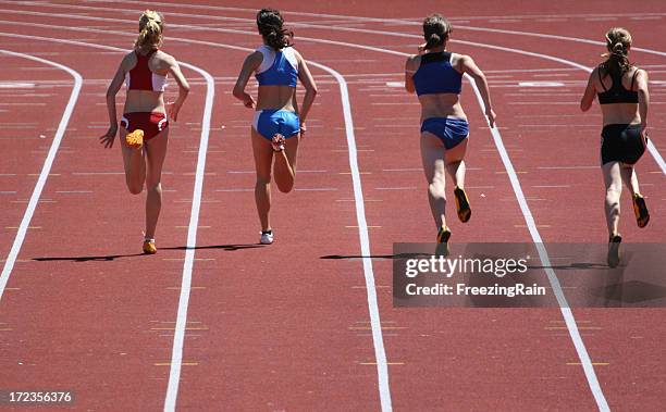 four women running the hundred meter race on a track - sports championship stock pictures, royalty-free photos & images