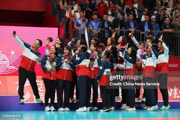 Bronze medalists Team Thailand pose for a group photo during the medal ceremony for the Volleyball - Women's Final on day 14 of the 19th Asian Games...