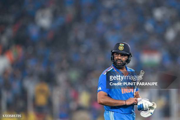 India's captain Rohit Sharma walks back to the pavilion after his dismissal during the 2023 ICC Men's Cricket World Cup one-day international match...