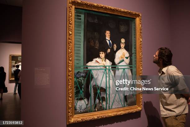 Man views a painting by French artist Edouard Manet during Manet/Degas Exhibition at the Metropolitan Museum of Art on October 6, 2023 in New York...