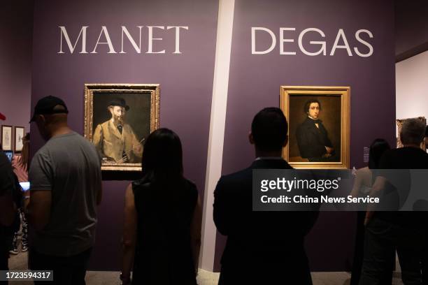 People view portraits of French artists Edgar Degas and Edouard Manet during Manet/Degas Exhibition at the Metropolitan Museum of Art on October 6,...
