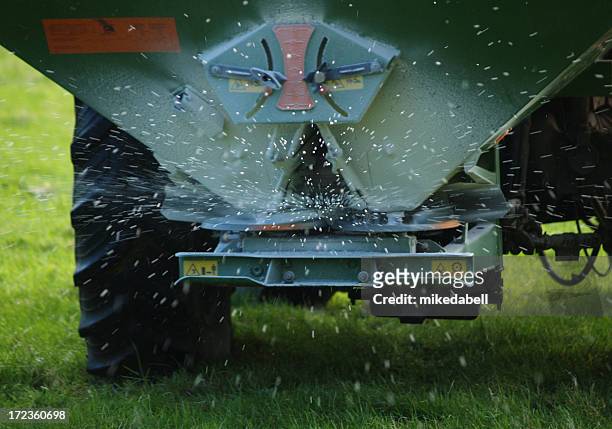 closeup of machine spreading fertilizer - spreading bildbanksfoton och bilder