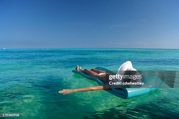 floating in the ocean - lilo stock pictures, royalty-free photos & images