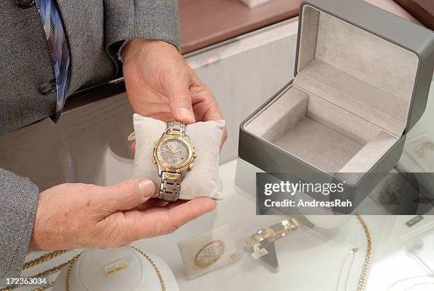 buying a wristwatch - jewelry store stock pictures, royalty-free photos & images