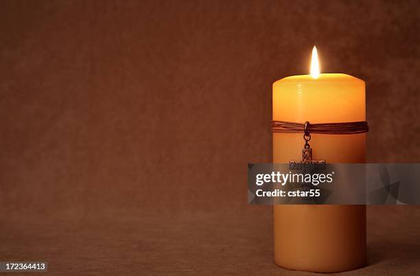 religious: burning candle with cross and copy space series - cross fire stock pictures, royalty-free photos & images