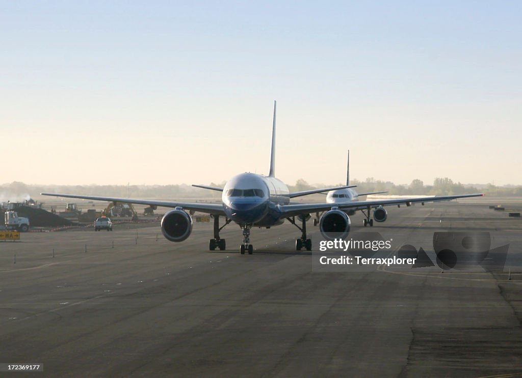 Airplanes Taxiing On Runway