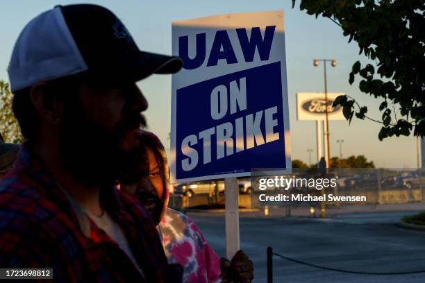 Factory workers and UAW union members form a picket line outside the Ford Motor Co. Kentucky Truck Plant in the early morning hours on October 14,...