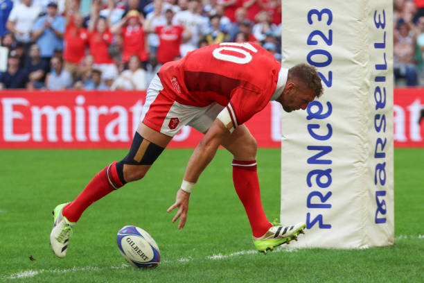 Wales' fly-half Dan Biggar grounds the ball to score Wales' first try during the France 2023 Rugby World Cup quarter-final match between Wales and...