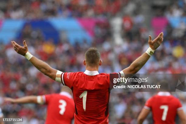 Wales' full-back Liam Williams gestures with the numbers partially fallen from his jersey during the France 2023 Rugby World Cup quarter-final match...