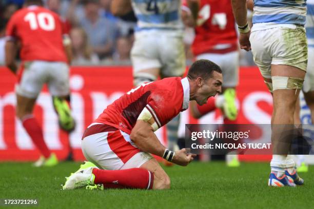 Wales' wing George North celebrates as teammate Wales' fly-half Dan Biggar crosses the line for a try during the France 2023 Rugby World Cup...