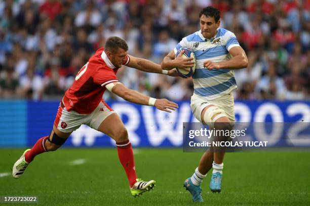 Argentina's flanker Juan Martín Gonzalez is tackled by Wales' fly-half Dan Biggar during the France 2023 Rugby World Cup quarter-final match between...