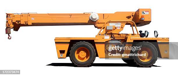 an orange crane with it's shadow on a white background - mobile crane stock pictures, royalty-free photos & images