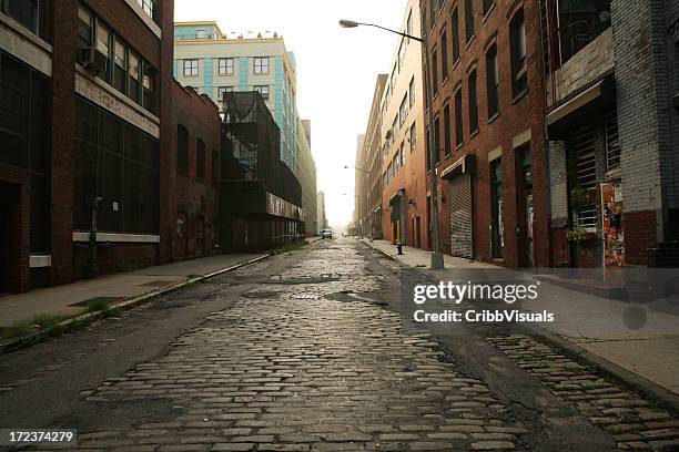 deserted brooklyn dumbo cobblestone backstreet morning - cobblestone stock pictures, royalty-free photos & images