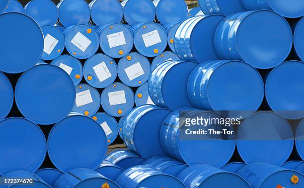 a warehouse full of blue hugh barrels  - chemical industry stock pictures, royalty-free photos & images