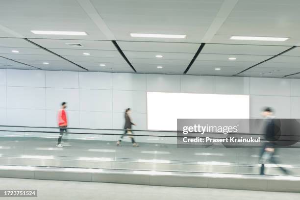 billboard at subway station. - moving airport escalator stock pictures, royalty-free photos & images