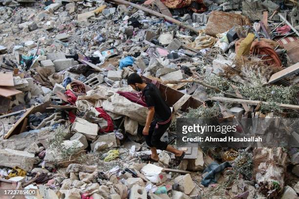 Palestinian citizens inspect damage to their homes caused by Israeli airstrikes on October 08, 2023 in Gaza City, Gaza. After the attack launched by...