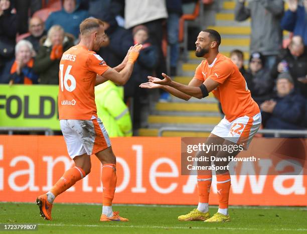 Blackpool's CJ Hamilton is congratulated on scoring his team's third goal by team mate Jordan Rhodes during the Sky Bet League One match between...