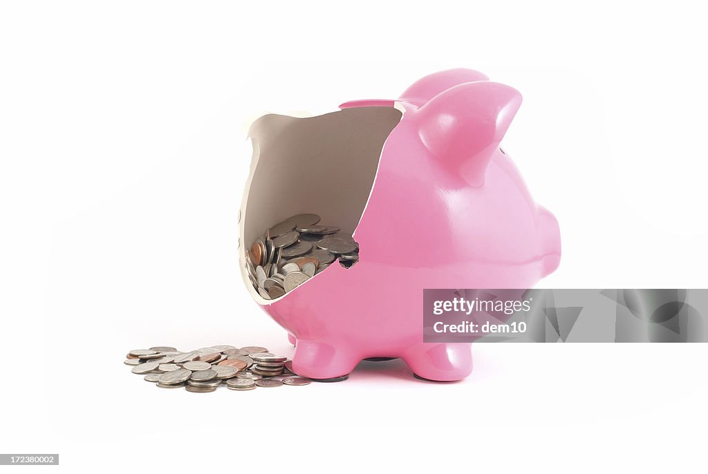 Broken piggy bank with money spilling out