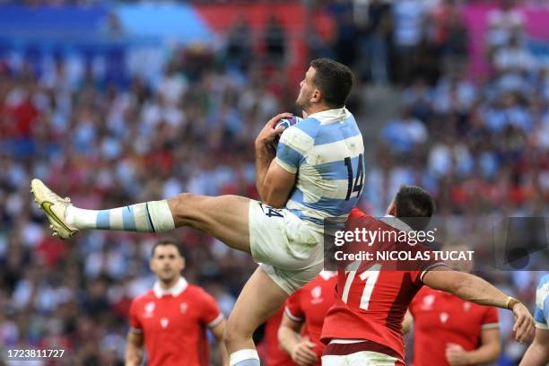 Argentina's right wing Emiliano Boffelli catches a high ball ahead of Wales' left wing Josh Adams during the France 2023 Rugby World Cup...