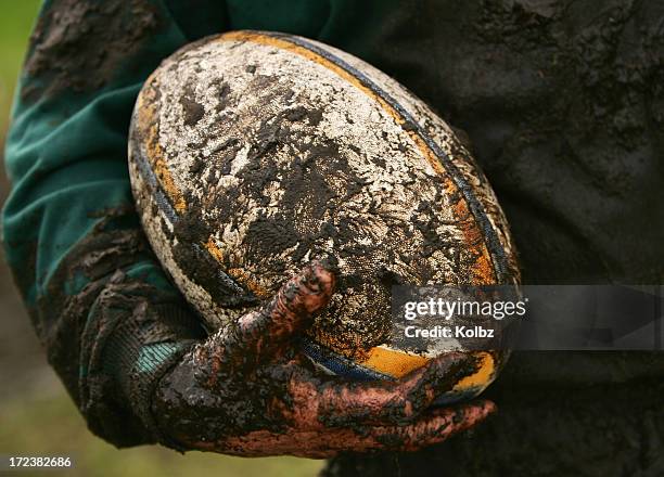 schlammigen rugby - rugby ball stock-fotos und bilder