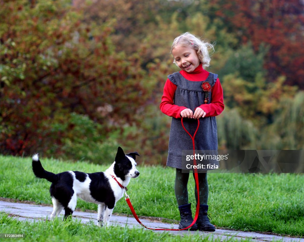 Lovely girl at the park with a dog