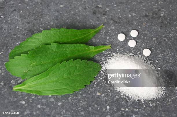 stevia leaves with pile of sugar - stevia stock pictures, royalty-free photos & images