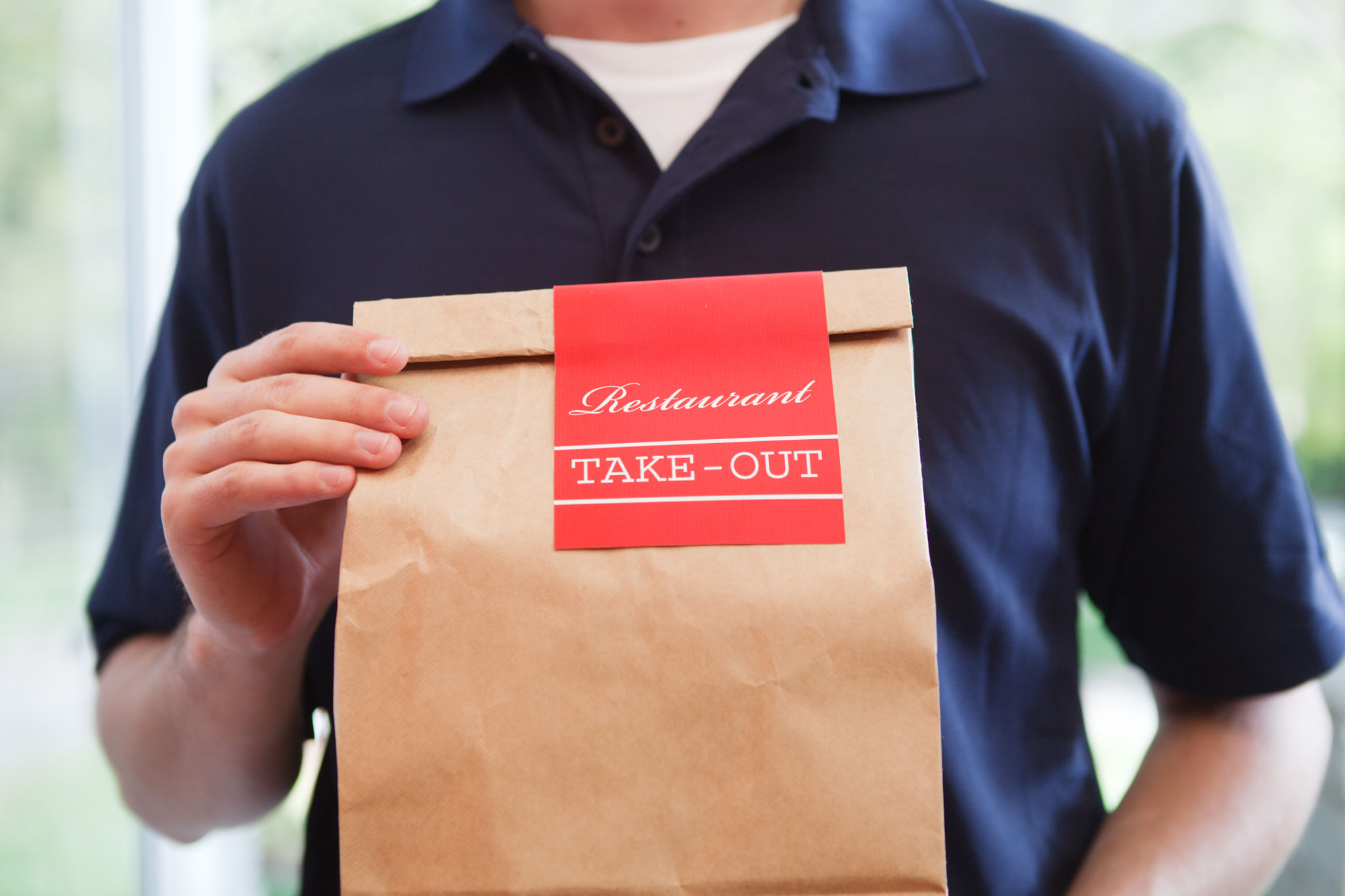 Take Out Food Delivery Person Holding Bag of Restaurant Dinner Take Out Food Delivery Person Holding Bag of Restaurant Dinner