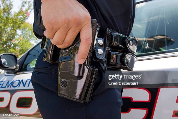 policeman at car with gun - police rescue stock pictures, royalty-free photos & images