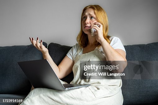 Upset Young Woman Dealing with Online Fraud: Indoor Scene with Natural Lighting