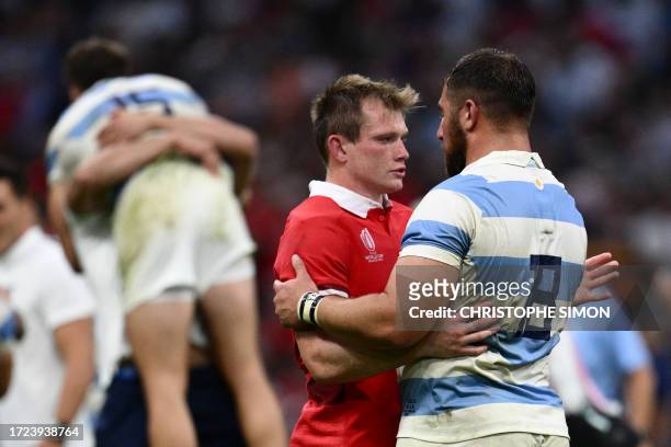 Wales' centre Nick Tompkins embraces Argentina's prop Eduardo Bello at the end of the France 2023 Rugby World Cup quarter-final match between Wales...
