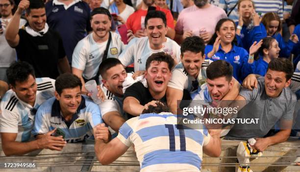 Argentina's supporters celebrate with Argentina's left wing Mateo Carreras after victory in the France 2023 Rugby World Cup quarter-final match...