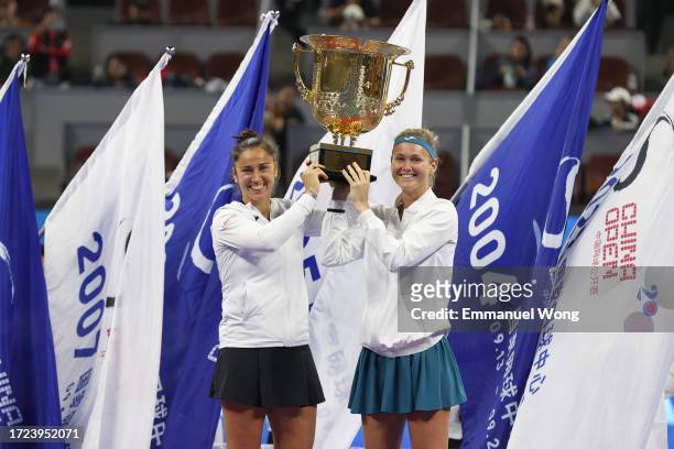 Marie Bouzkova of the Czech Republic and Sara Sorribes Tormo of Spain pose with the trophy after the medal ceremony following the Women's double...
