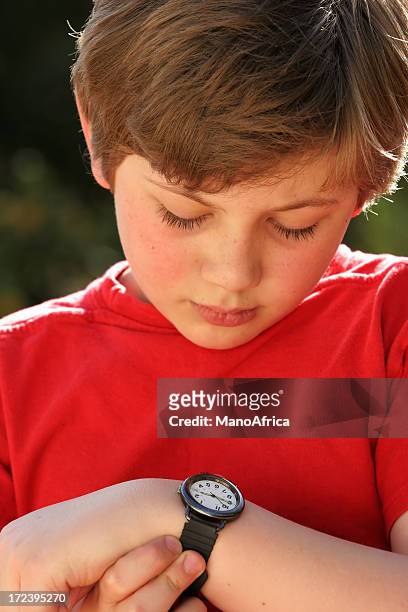 schoolboy learning to tell time - only boys stock pictures, royalty-free photos & images