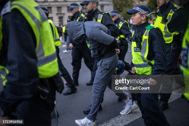 Man is arrested as people protest in support of Palestine on October 14, 2023 in London, United Kingdom. Groups supporting Palestine protest at...